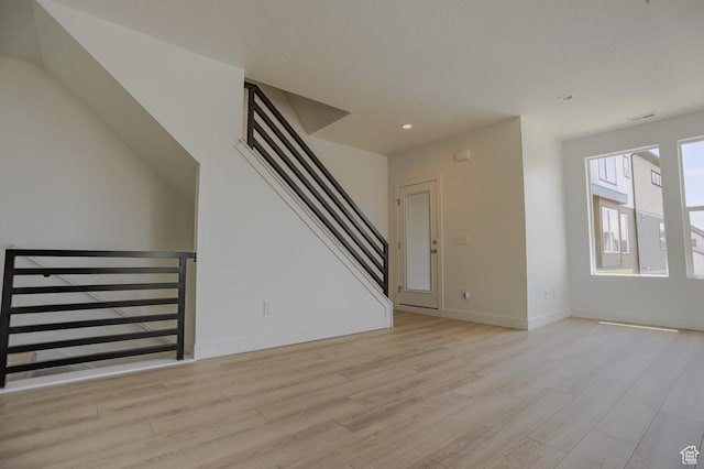 140 E Abbeville Ct, Sandy, UT 84070 - unfurnished living room featuring light wood-style floors, stairway, and recessed lighting