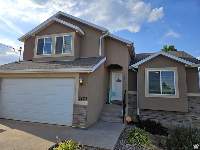 2175 E 1000 N, Ballard, UT 84066 - view of front of house with stucco siding, a garage, driveway, and roof with shingles