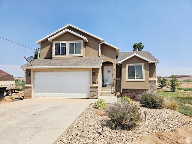 2175 E 1000 N, Ballard, UT 84066 - view of front of home with stucco siding, an attached garage, concrete driveway, brick siding, and a shingled roof