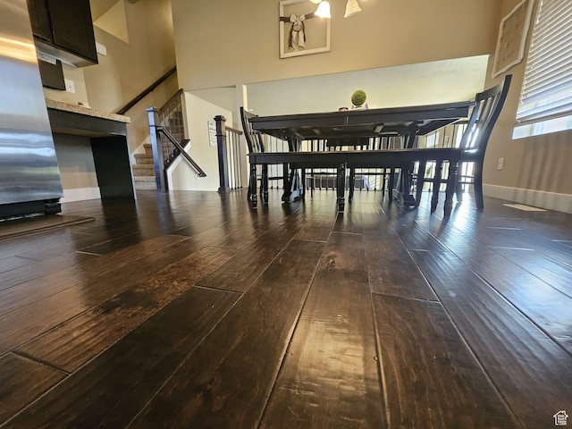 2175 E 1000 N, Ballard, UT 84066 - dining space featuring dark wood finished floors, a towering ceiling, and stairway