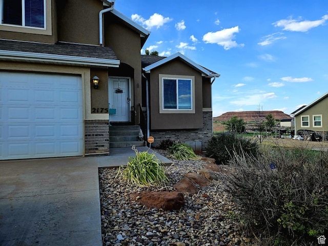 2175 E 1000 N, Ballard, UT 84066 - view of front of home with stucco siding, brick siding, and driveway