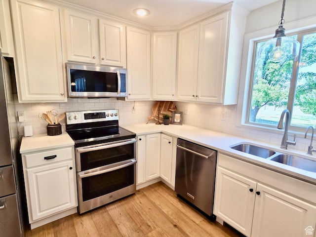3501 E Golden Eagle Rd N, Eagle Mountain, UT 84005 - kitchen featuring stainless steel appliances, backsplash, light wood finished floors, white cabinetry, and recessed lighting