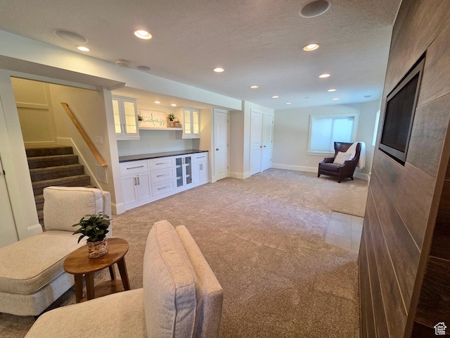 3501 E Golden Eagle Rd N, Eagle Mountain, UT 84005 - living area with light colored carpet, stairs, bar, and recessed lighting