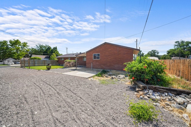 195 S Center St, American Fork, UT 84003 - view of side of home with brick siding and a patio area