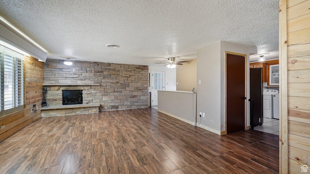 195 S Center St, American Fork, UT 84003 - unfurnished living room featuring washer / dryer, a fireplace, wood finished floors, a ceiling fan, and a textured ceiling