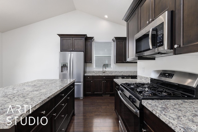 1608 N 500 E, North Ogden, UT 84404 - kitchen with stainless steel appliances, dark wood-type flooring, vaulted ceiling, dark brown cabinets, and light stone countertops