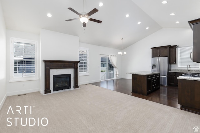 1608 N 500 E, North Ogden, UT 84404 - kitchen with appliances with stainless steel finishes, ceiling fan, a center island, dark brown cabinetry, and a high end fireplace