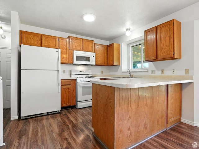 3992 S 4665 W, West Valley City, UT 84120 - kitchen with white appliances, a peninsula, dark wood-style floors, brown cabinets, and light countertops