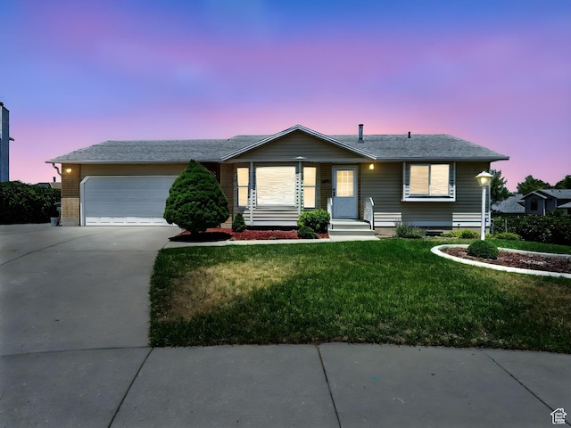 3992 S 4665 W, West Valley City, UT 84120 - ranch-style home with driveway, a lawn, and an attached garage