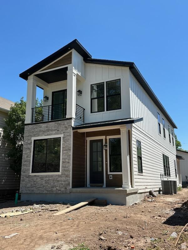 1361 S Lincoln St, Salt Lake City, UT 84105 - view of front facade featuring a balcony, covered porch, and board and batten siding