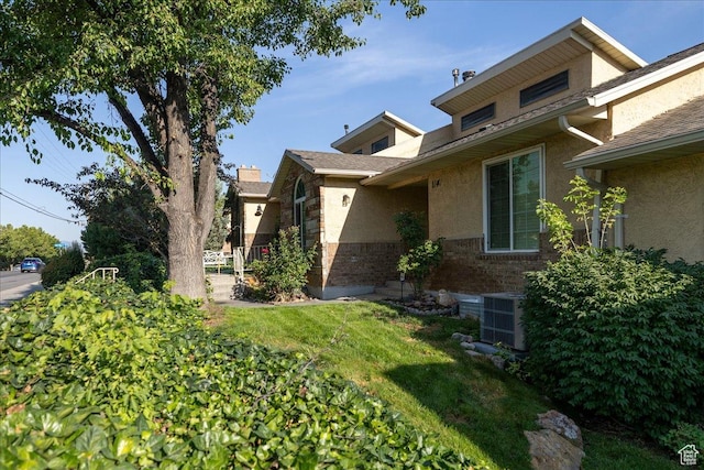 1141 E Murray Holladay Rd S, Millcreek, UT 84117 - view of home's exterior featuring stucco siding, a lawn, and stone siding