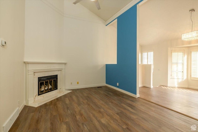 1141 E Murray Holladay Rd S, Millcreek, UT 84117 - unfurnished living room featuring a premium fireplace, wood finished floors, ceiling fan, and high vaulted ceiling