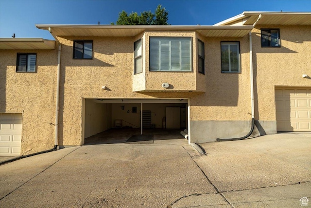 1141 E Murray Holladay Rd S, Millcreek, UT 84117 - view of front of house featuring stucco siding, driveway, and a garage