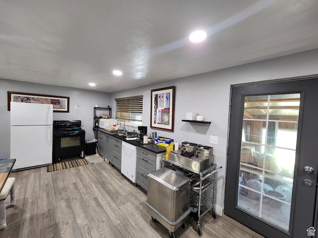 6319 W 13400 S, Herriman, UT 84096 - kitchen with white appliances, dark countertops, light wood-type flooring, and recessed lighting