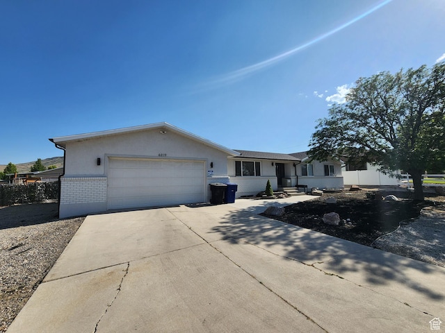 6319 W 13400 S, Herriman, UT 84096 - ranch-style house with driveway, a garage, stucco siding, and brick siding
