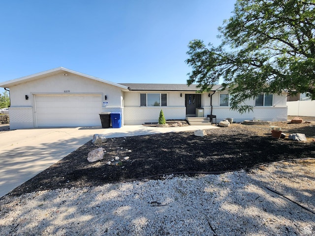 6319 W 13400 S, Herriman, UT 84096 - ranch-style house with brick siding, an attached garage, and driveway
