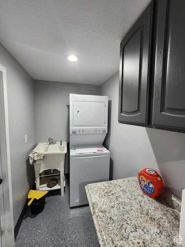 6319 W 13400 S, Herriman, UT 84096 - laundry room featuring estacked washer and dryer, recessed lighting, and cabinet space
