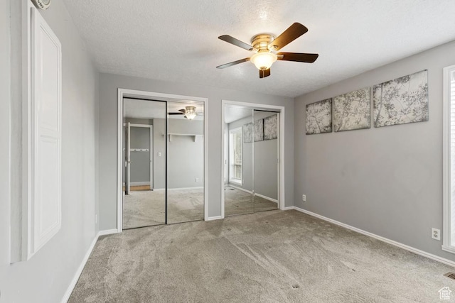 24725 N 11925 E, Fairview, UT 84629 - unfurnished bedroom with two closets, carpet floors, a textured ceiling, and a ceiling fan