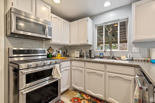 24725 N 11925 E, Fairview, UT 84629 - kitchen featuring stainless steel appliances, white cabinetry, light wood-type flooring, and recessed lighting