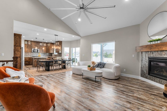 13703 S Blayde Dr, Herriman, UT 84096 - living area with wood finished floors, high vaulted ceiling, recessed lighting, and a fireplace