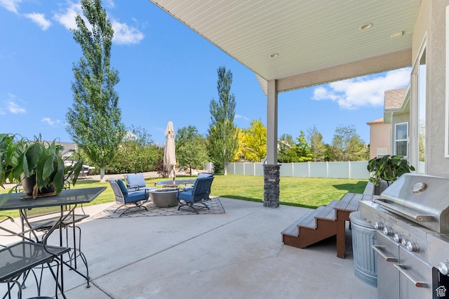 13703 S Blayde Dr, Herriman, UT 84096 - fenced backyard with a fire pit, a patio, and an outdoor kitchen