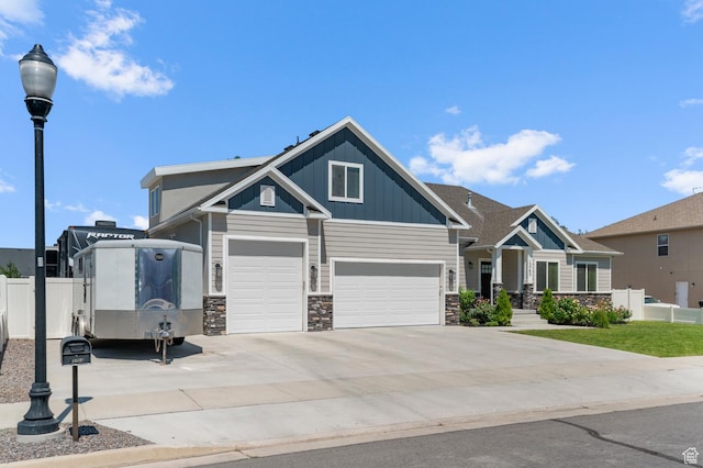 13703 S Blayde Dr, Herriman, UT 84096 - craftsman house featuring stone siding, an attached garage, concrete driveway, and board and batten siding