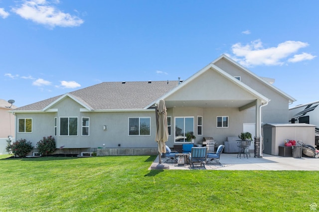 13703 S Blayde Dr, Herriman, UT 84096 - back of house featuring stucco siding, a patio, and a lawn