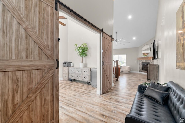 13703 S Blayde Dr, Herriman, UT 84096 - hallway featuring a barn door, light wood-type flooring, and recessed lighting