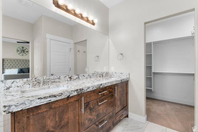 13703 S Blayde Dr, Herriman, UT 84096 - ensuite bathroom featuring double vanity and baseboards