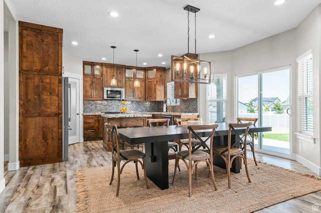 13703 S Blayde Dr, Herriman, UT 84096 - dining area with plenty of natural light, recessed lighting, light wood-style flooring, and a chandelier