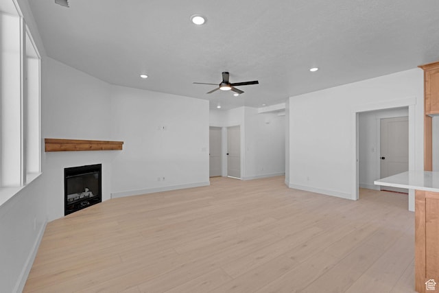 496 S 30 E, Franklin, ID 83237 - unfurnished living room with ceiling fan, a fireplace, light wood finished floors, and recessed lighting
