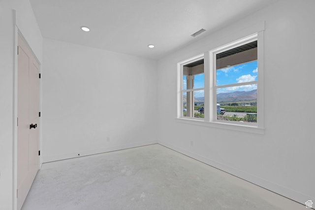 496 S 30 E, Franklin, ID 83237 - unfurnished room with concrete flooring, a mountain view, and recessed lighting