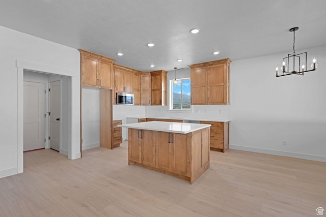 496 S 30 E, Franklin, ID 83237 - kitchen featuring stainless steel microwave, a chandelier, a center island, light countertops, and light wood-style floors