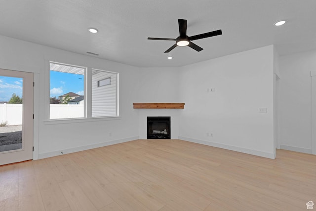 496 S 30 E, Franklin, ID 83237 - unfurnished living room featuring ceiling fan, a fireplace, light wood-style floors, and recessed lighting