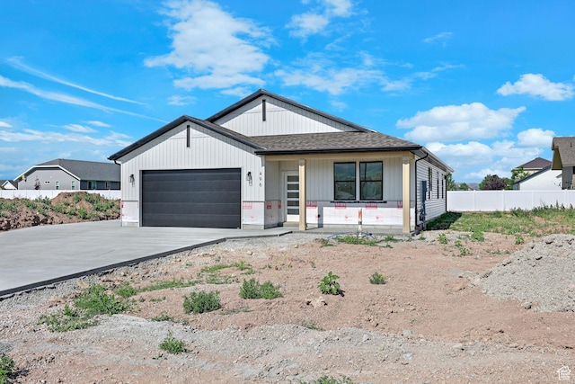 496 S 30 E, Franklin, ID 83237 - modern farmhouse style home featuring concrete driveway, a porch, a garage, and a shingled roof