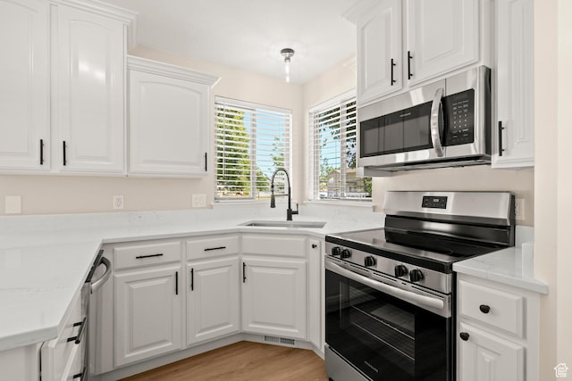 4012 N Bounty Cv W, Lehi, UT 84043 - kitchen featuring stainless steel appliances, white cabinets, light countertops, and light wood-type flooring
