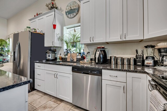 3981 S 500 E, Millcreek, UT 84107 - kitchen with stainless steel appliances, white cabinets, and dark stone countertops