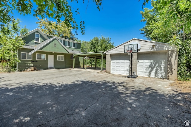 3981 S 500 E, Millcreek, UT 84107 - view of front facade with an outbuilding, a detached garage, and asphalt driveway