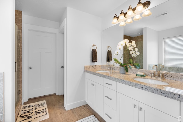 4925 E Breezy Patch Rd, Eagle Mountain, UT 84005 - bathroom with double vanity, a shower stall, and wood finished floors