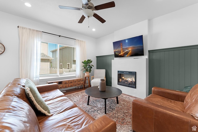 4925 E Breezy Patch Rd, Eagle Mountain, UT 84005 - living room featuring a ceiling fan, a glass covered fireplace, wood finished floors, and recessed lighting