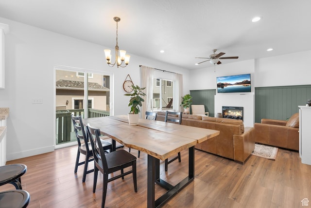 4925 E Breezy Patch Rd, Eagle Mountain, UT 84005 - dining room featuring a ceiling fan, a glass covered fireplace, light wood-type flooring, recessed lighting, and a chandelier