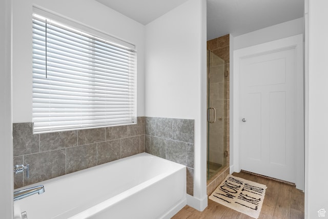 4925 E Breezy Patch Rd, Eagle Mountain, UT 84005 - bathroom with a garden tub, wood finished floors, and a shower stall