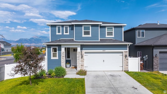 4925 E Breezy Patch Rd, Eagle Mountain, UT 84005 - view of front of property featuring a mountain view, an attached garage, stone siding, and concrete driveway