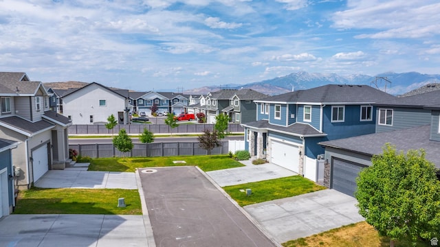 4925 E Breezy Patch Rd, Eagle Mountain, UT 84005 - view of yard with a residential view, a mountain view, and concrete driveway