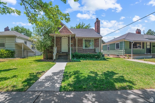 722 E 50 S, Provo, UT 84606 - bungalow-style house featuring a porch, brick siding, a front yard, and a chimney