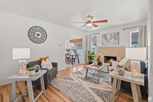 722 E 50 S, Provo, UT 84606 - living area featuring a ceiling fan, light wood finished floors, and a lit fireplace
