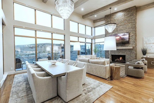 6423 Golden Bear Loop Unit 5, Park City, UT 84098 - dining area with a chandelier, wood finished floors, beamed ceiling, a towering ceiling, and a stone fireplace