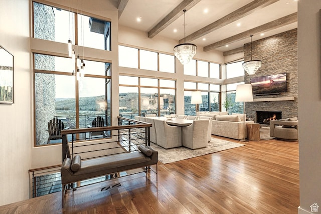 6423 Golden Bear Loop Unit 5, Park City, UT 84098 - living room with wood finished floors, a high ceiling, beam ceiling, a fireplace, and a chandelier