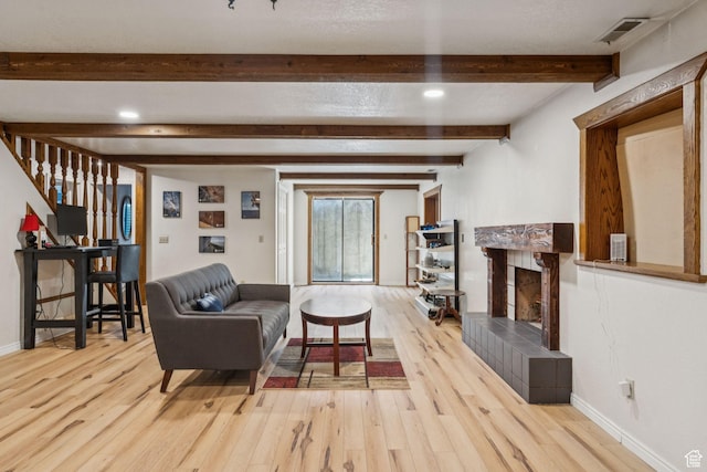 10148 S Roseboro Rd, Sandy, UT 84092 - living area with light wood-style floors, beam ceiling, a fireplace, and stairway