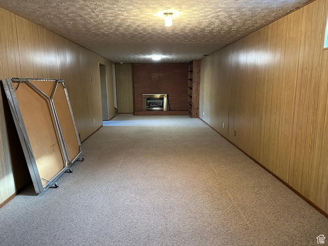487 Highland Blvd, Brigham City, UT 84302 - finished basement with a brick fireplace, light carpet, wooden walls, and a textured ceiling
